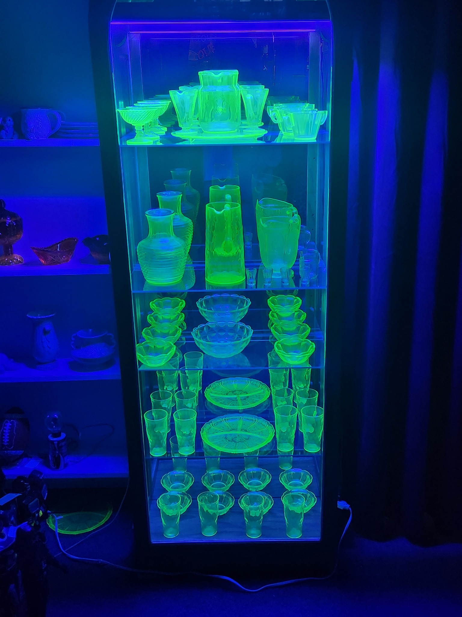 Uranium glass collection glowing under UV light